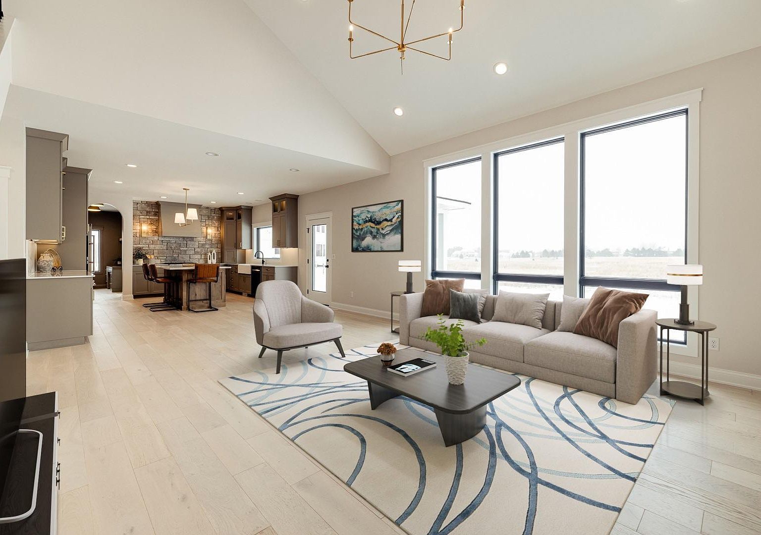 The open-plan dining and great-room view from the kitchen at 2762 Mayo Prairie: a wall of prairie-view windows on the right, a vaulted ceiling rising to the alder feature, with a clear sight line back to the front entry