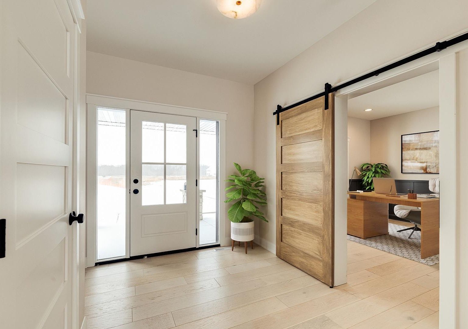 The front entry at 2762 Mayo Prairie Lane: a glass-paned front door beside a stained barn-style sliding door that opens into the private office, with white oak floors and a tall potted plant